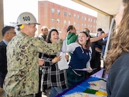 Capt. JD Crinklaw, commander, Puget Sound Naval Shipyard & Intermediate Maintenance Facility, high-fives employees, May 21, 2024, during a Pathway to Safety campaign event in Bremerton, Washington. (U.S. Navy photo by Wendy Hallmark)