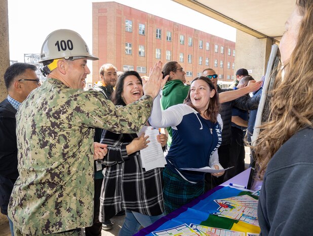 Capt. JD Crinklaw, commander, Puget Sound Naval Shipyard & Intermediate Maintenance Facility, high-fives employees, May 21, 2024, during a Pathway to Safety campaign event in Bremerton, Washington. (U.S. Navy photo by Wendy Hallmark)