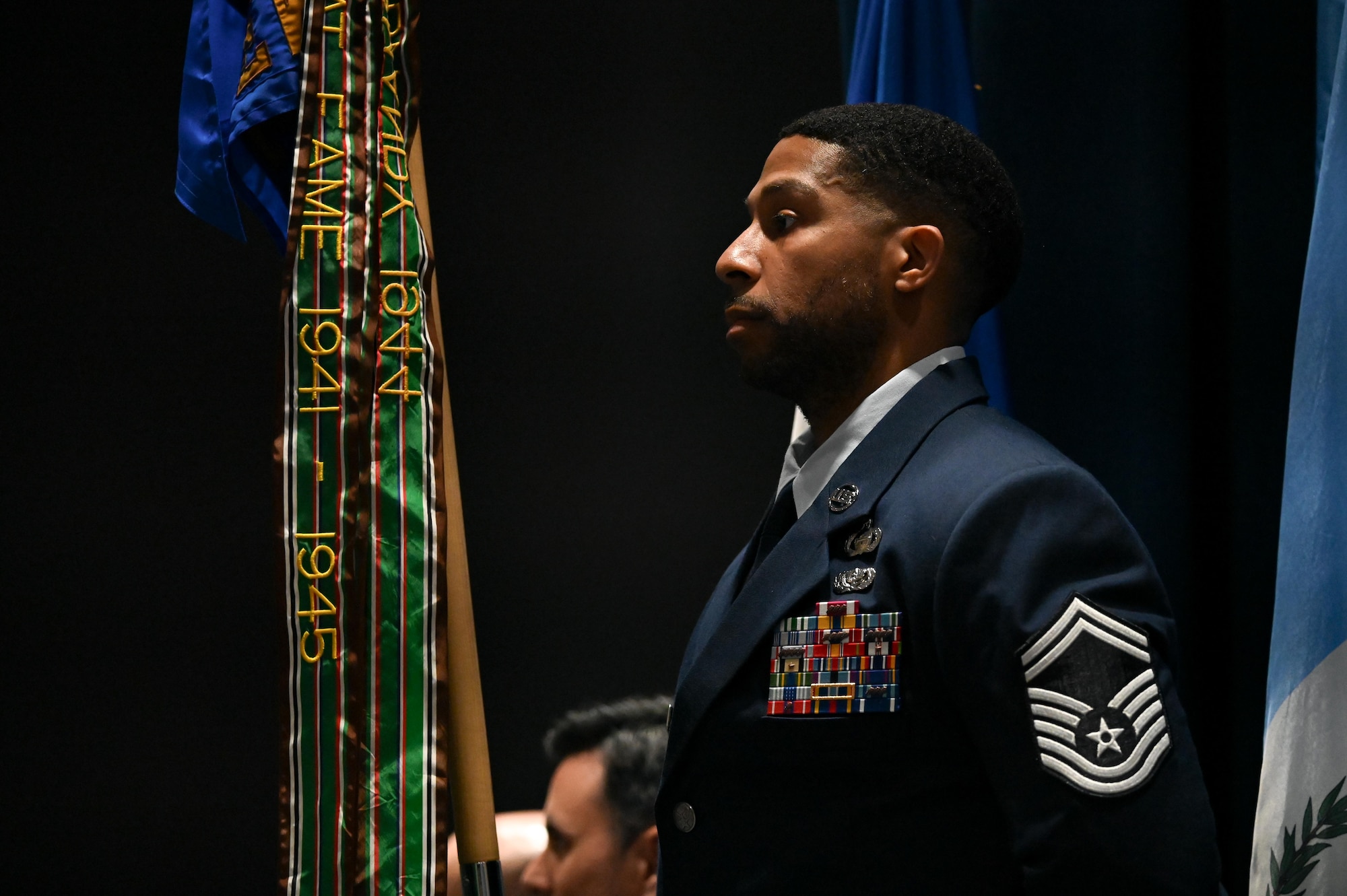 U.S. Air Force Senior Master Sgt. James Johnson, 453rd Electronic Warfare Squadron senior enlisted leader, holds the unit’s guidon during the 453rd EWS change of command ceremony at Joint Base San Antonio-Lackland, Texas, June 3, 2024. The 453rd EWS is comprised of the Analysis Flight, Software Development Flight, Cyber Defense Operations Flight, Modeling, Simulation, and Analysis Engineering Flight, and Plans and Programs located at Joint Base San Antonio-Lackland. (U.S. Air Force photo by Capt. Benjamin Aronson)
