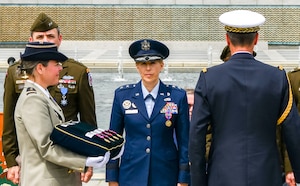 U.S. and Frech military stand during a ceremony.