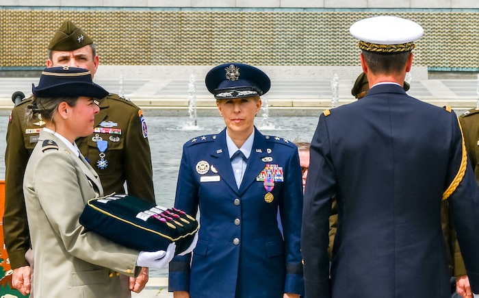 U.S. and Frech military stand during a ceremony.