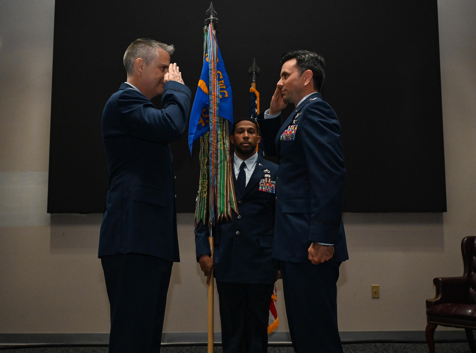 U.S. Air Force Col. Andrew Finkler, 850th Spectrum Warfare Group commander, left, salutes U.S. Air Force Lt. Col. Cameron Unterberger, 453rd Electronic Warfare Squadron commander, right, during the 453rd EWS change of command ceremony at Joint Base San Antonio-Lackland, Texas, June 3, 2024. The 453rd EWS enables electromagnetic spectrum war fighting dominance by engineering and developing digital-native solutions supporting global signal intelligence analysis, electronic warfare engineering modeling analytics, and large-force synthetic battle spaces to enhance combatant command readiness. (U.S. Air Force photo by Capt. Benjamin Aronson)