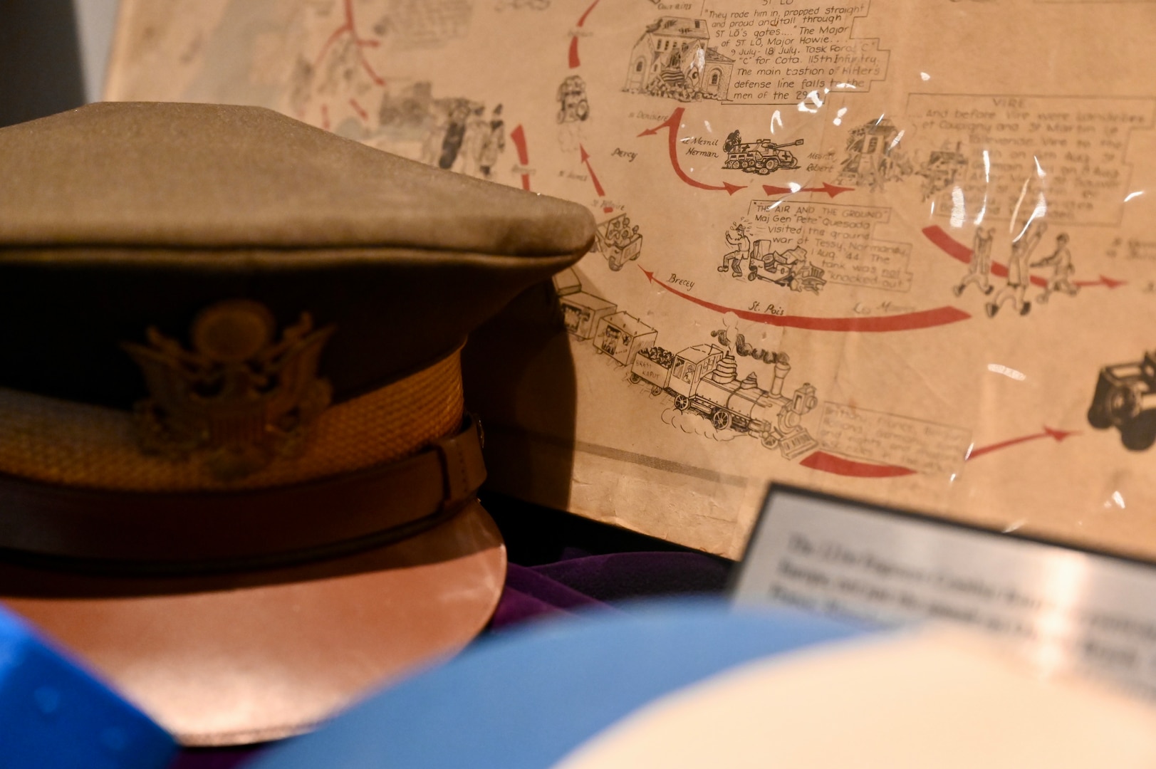 A collection of World War II artifacts is on display in the District of Columbia National Guard Museum highlighting the contributions of eight mobilized units in support of the war in Europe, the Pacific and at home, June 5, 2024. Three landed on Omaha Beach and fought in the Battle of Normandy or Operation Overlord (D-Day): The 29th Military Police Platoon (MP PLT), Headquarters and Headquarters Company (HHC) of the 29th Infantry Division (29ID), and the 121st Engineer Combat Battalion (ECB).