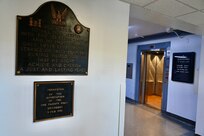 A plaque hangs in the foyer of the D.C. Armory commemorating the efforts of the  121st Engineer Combat Battalion (ECB) in support of WWII, June 5, 2024. Combat engineers proved critical to the success of Operation Overlord, clearing obstacles located on the beaches, the beach exits and coastal roads, thus enabling forces to rapidly advance from the beaches and to drive into Normandy.
