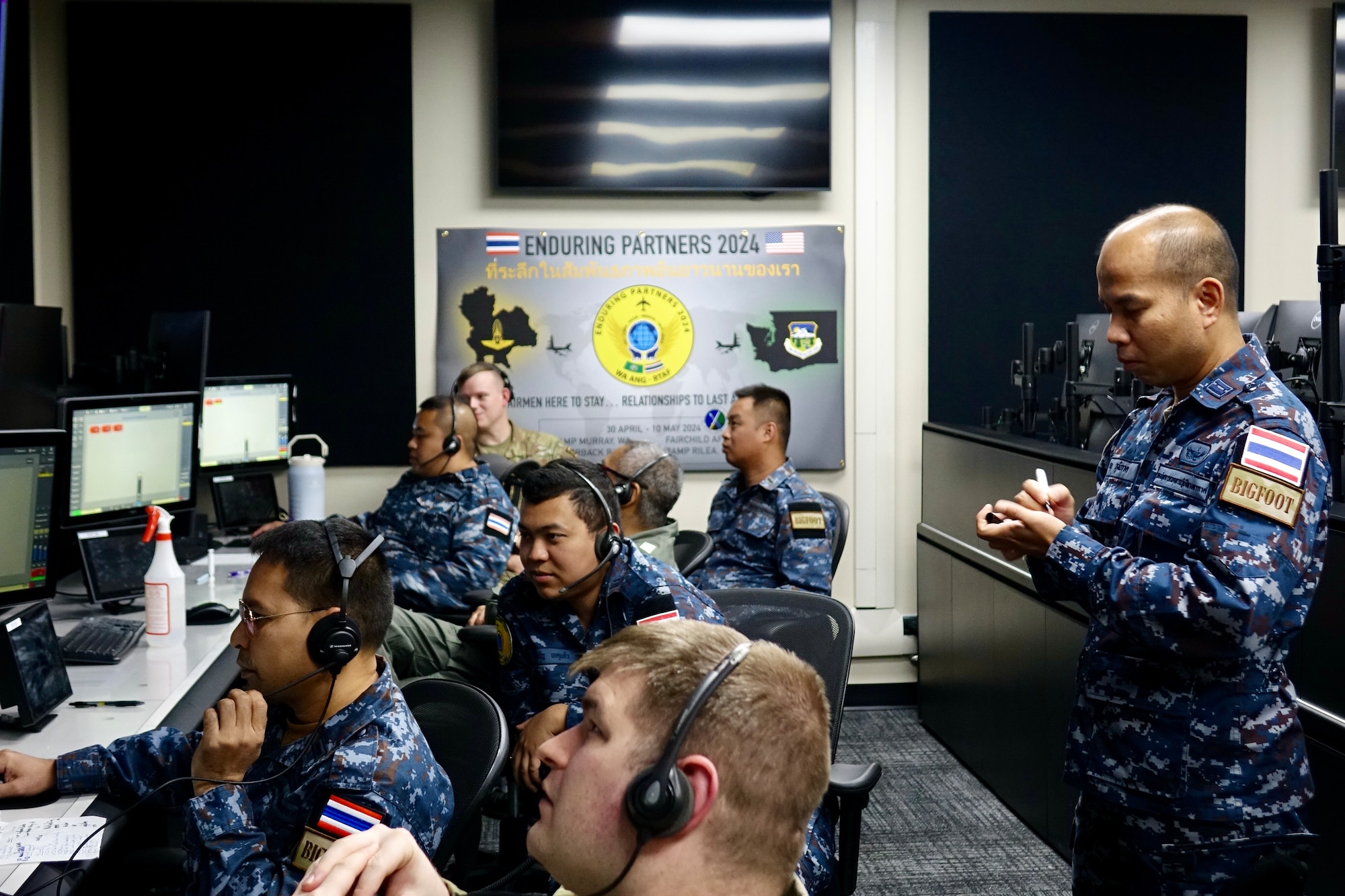 Airmen looking at computer screens.