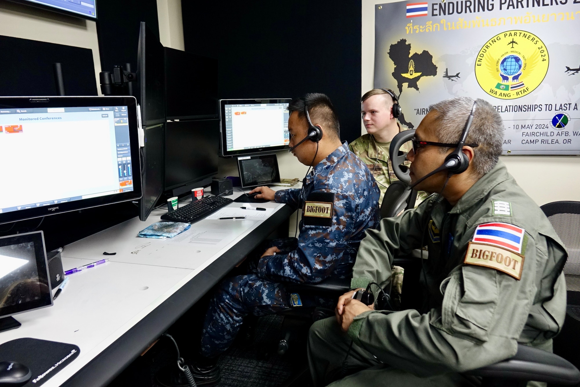 Airmen looking at computer screens