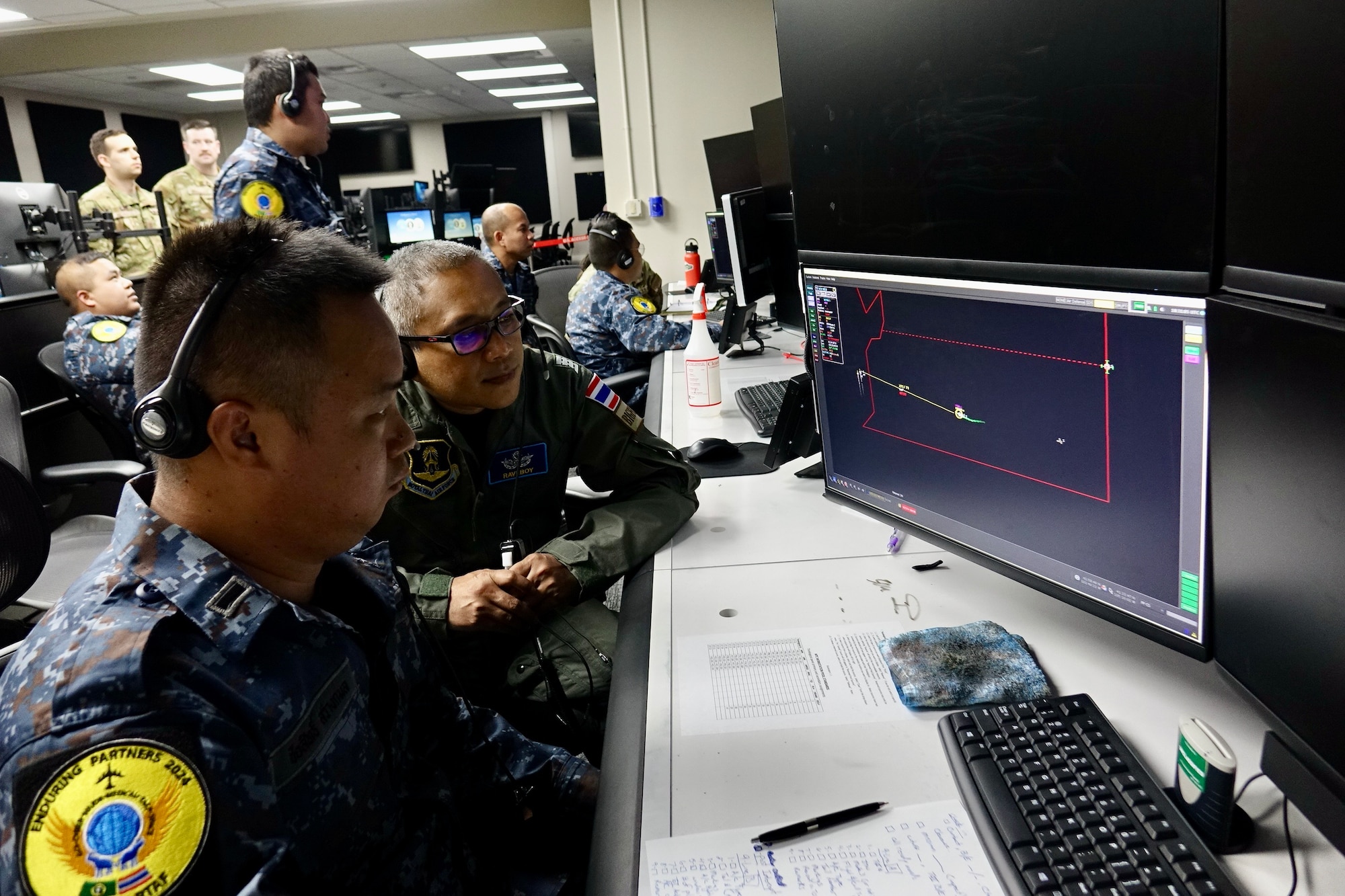 Royal Thai Air Force Airmen looking at a computer screen