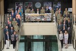 military and civilian leaders pose for a photo at DLA Headquarters main staircase during the annual service day