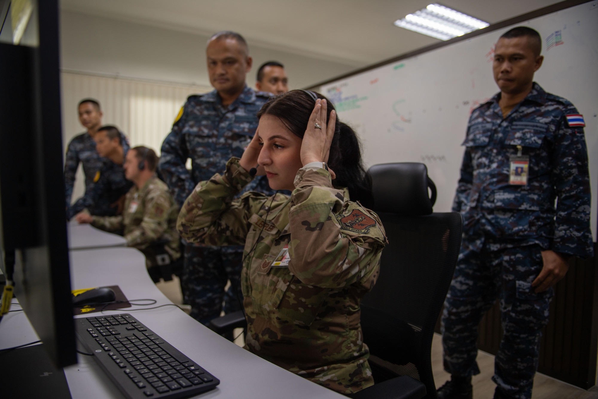 Airmen looking at computer screens