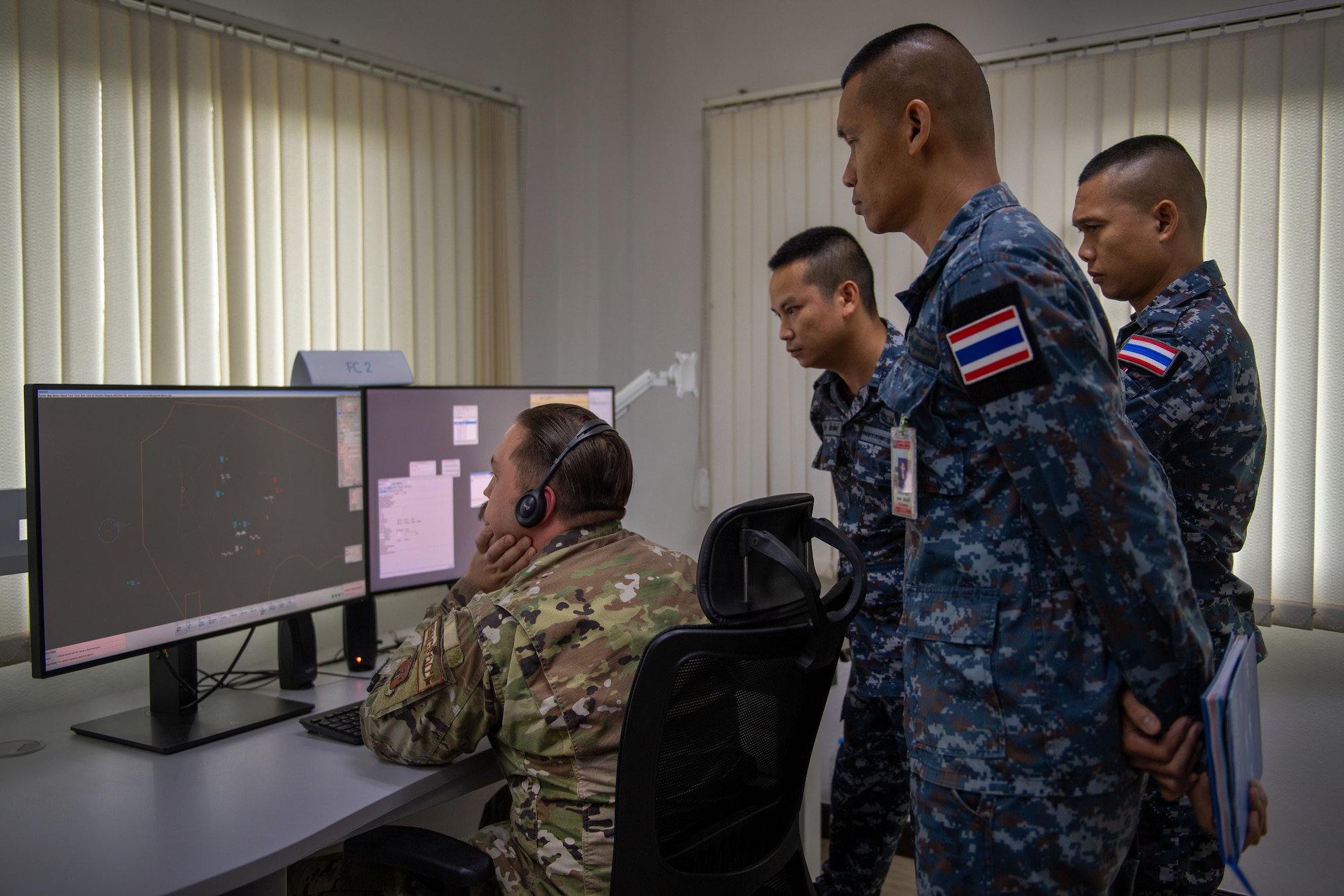 Airmen looking at a computer screen