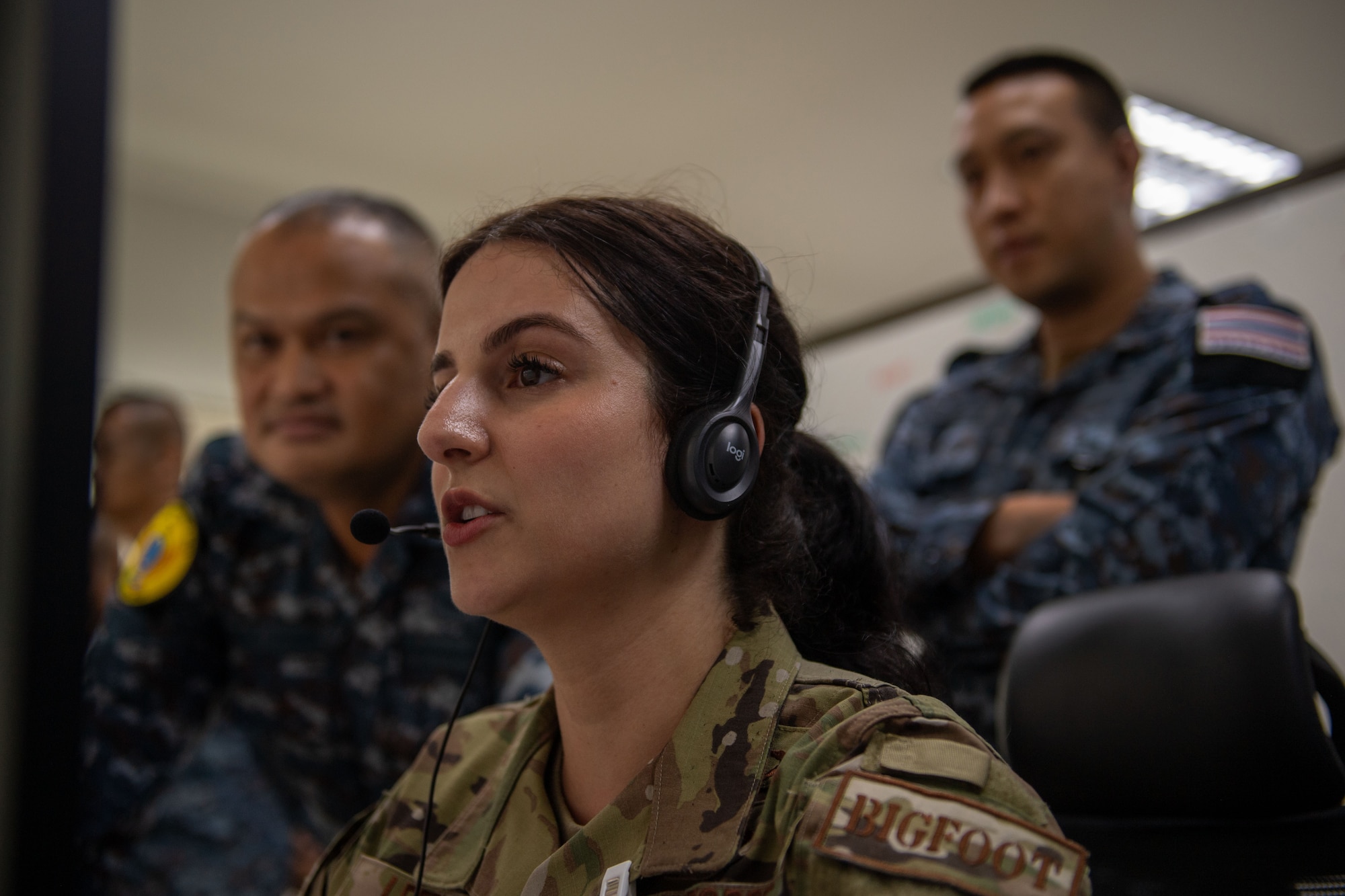 Airmen looking at a computer screen