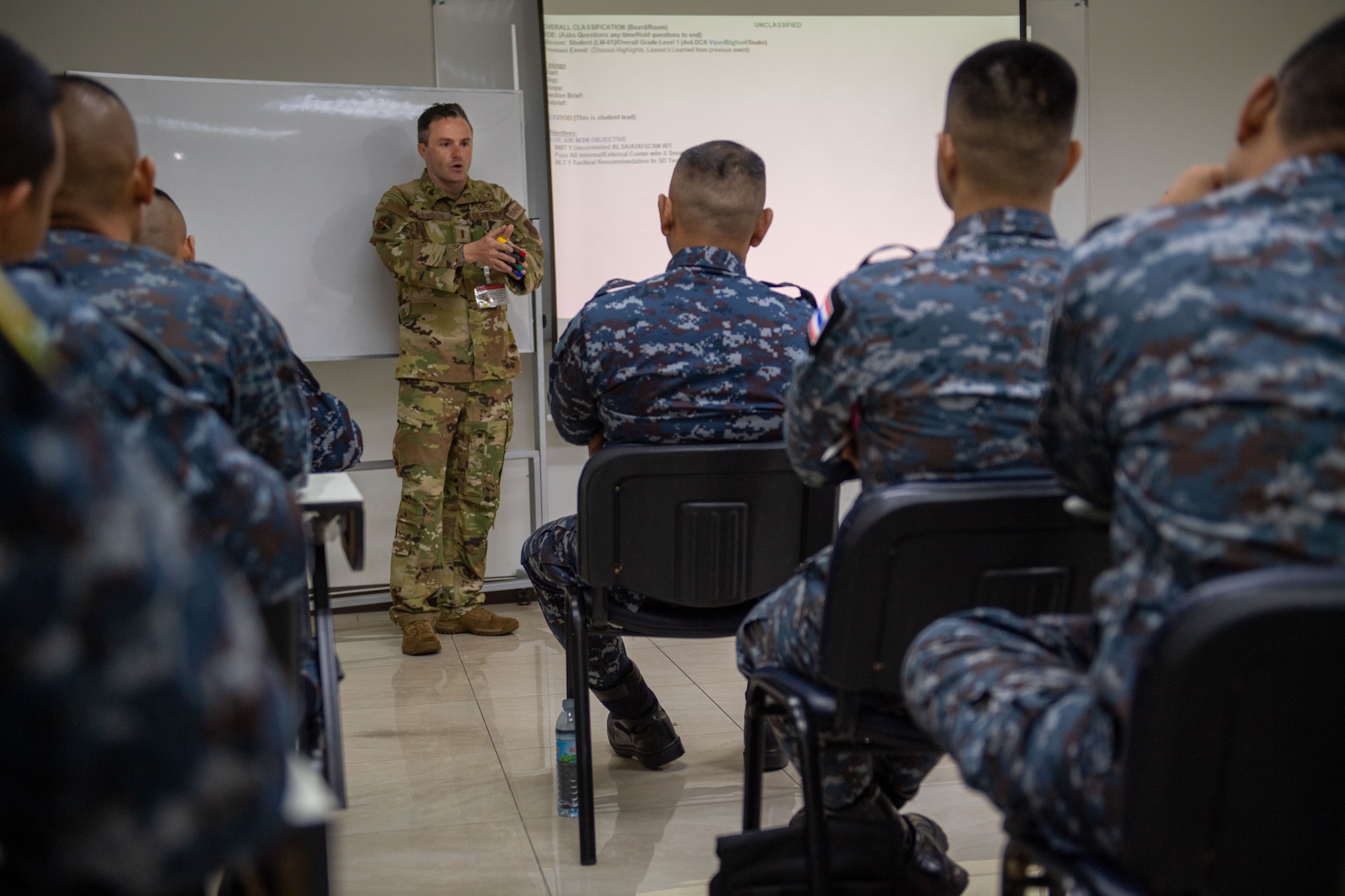 Airmen listening to a briefing