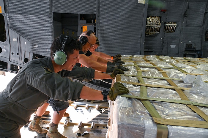 men pushing pallets