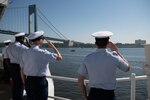 Crewmembers from the U.S. Coast Guard Cutter Calhoun (WMSL 759) salute during the parade of ships at Fleet Week in New York City, May 22, 2024. The Parade of ships is a time-honored tradition that allows the American public to see vessels of the U.S. Navy and U.S. Coast Guard transit New York Harbor. (U.S. Coast Guard photo by Lt. j. g. Adam Warren)