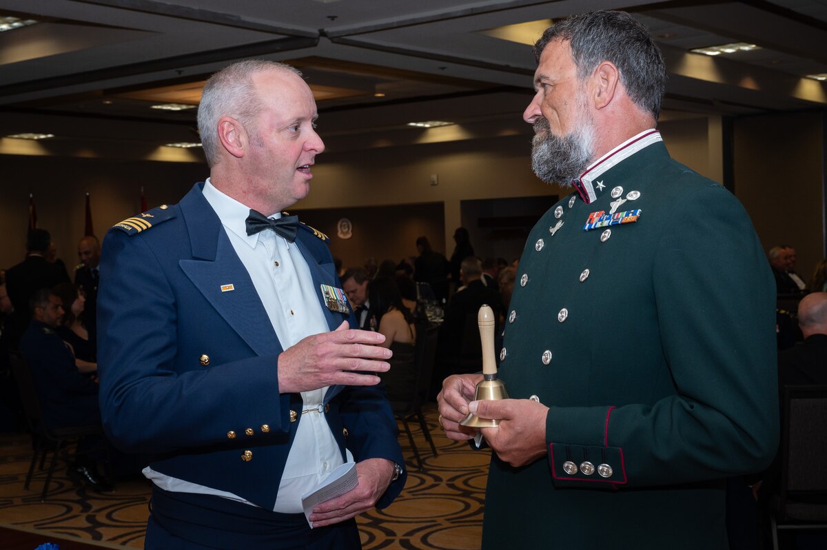 Two men talk during the AFSAC/FLO international reception