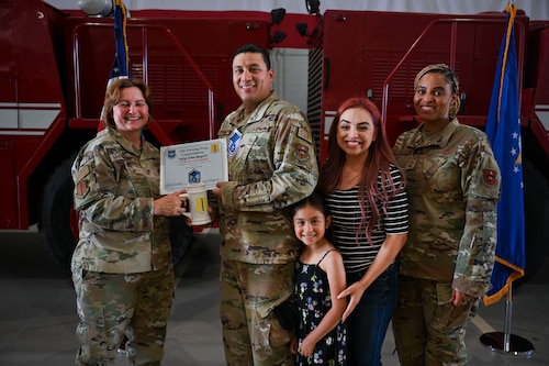 U.S. Air Force Col. Angelina Maguinness, 17th Training Wing commander, and Chief Master Sgt. Khamillia Washington, 17th Training Wing command chief, present Master Sgt. select Julian Rangel, assigned to the 17th Security Forces Squadron, his promotion certificate during a master sergeant release party at the Louis F. Garland Department of Defense Fire Academy, Goodfellow Air Force Base, Texas, June 5, 2024. Master sergeants are transitioning from working as technical experts and frontline supervisors into a dedicated administration role while growing their technical and managerial talents. (U.S. Air Force photo by Airman 1st Class Madison Collier)