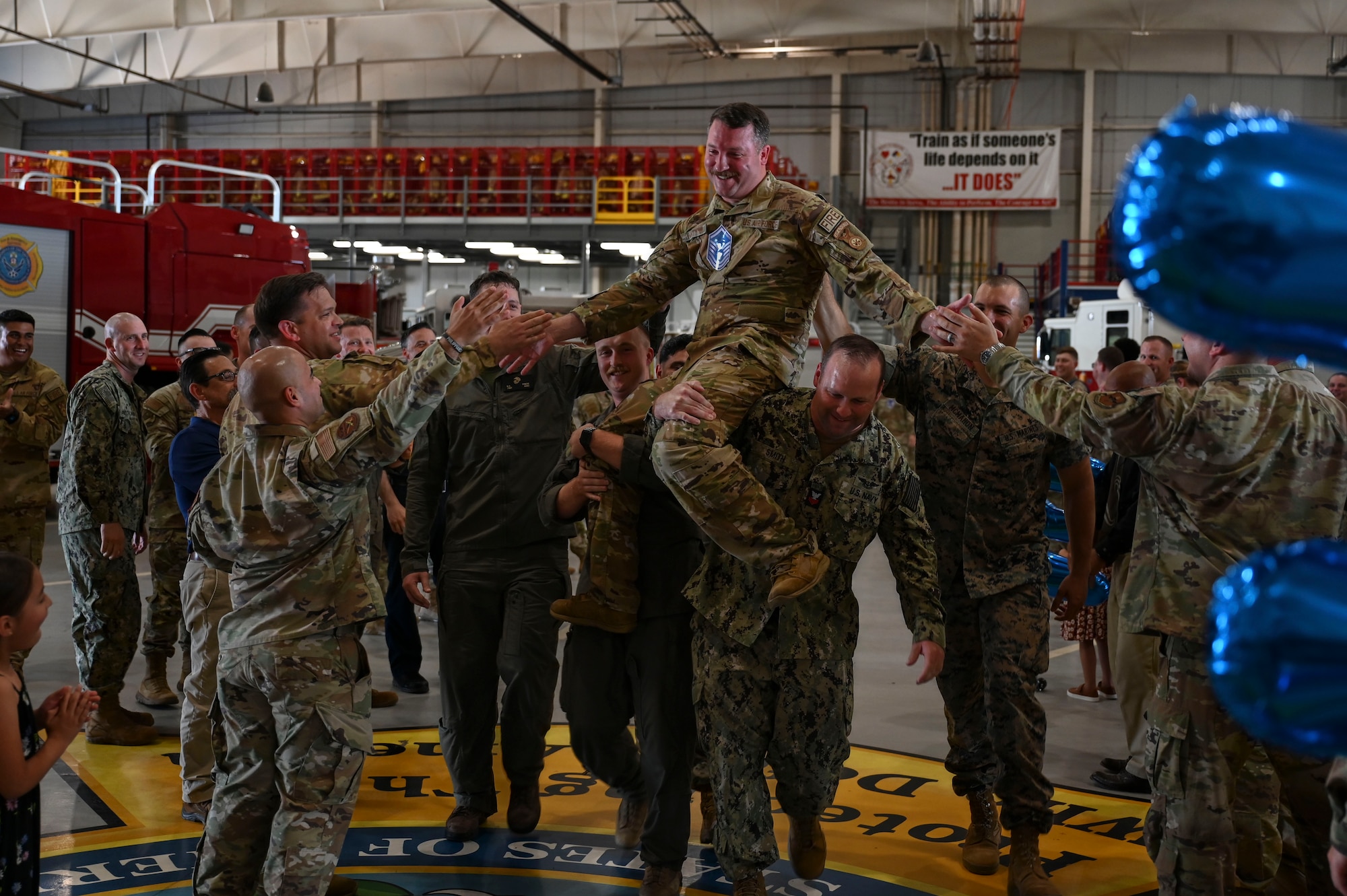 U.S. Air Force Master Sgt. select John Whitmyer, assigned to the 312th Training Squadron, is carried through a crowd of supporters during a master sergeant release party at the Louis F. Garland Department of Defense Fire Academy, Goodfellow Air Force Base, Texas, June 5, 2024. Coworkers and family members congratulated the selectees before they received their certificates. (U.S. Air Force photo by Airman 1st Class Madison Collier)