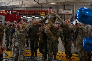 U.S. Air Force Master Sgt. select John Whitmyer, assigned to the 312th Training Squadron, is carried through a crowd of supporters during a master sergeant release party at the Louis F. Garland Department of Defense Fire Academy, Goodfellow Air Force Base, Texas, June 5, 2024. Coworkers and family members congratulated the selectees before they received their certificates. (U.S. Air Force photo by Airman 1st Class Madison Collier)