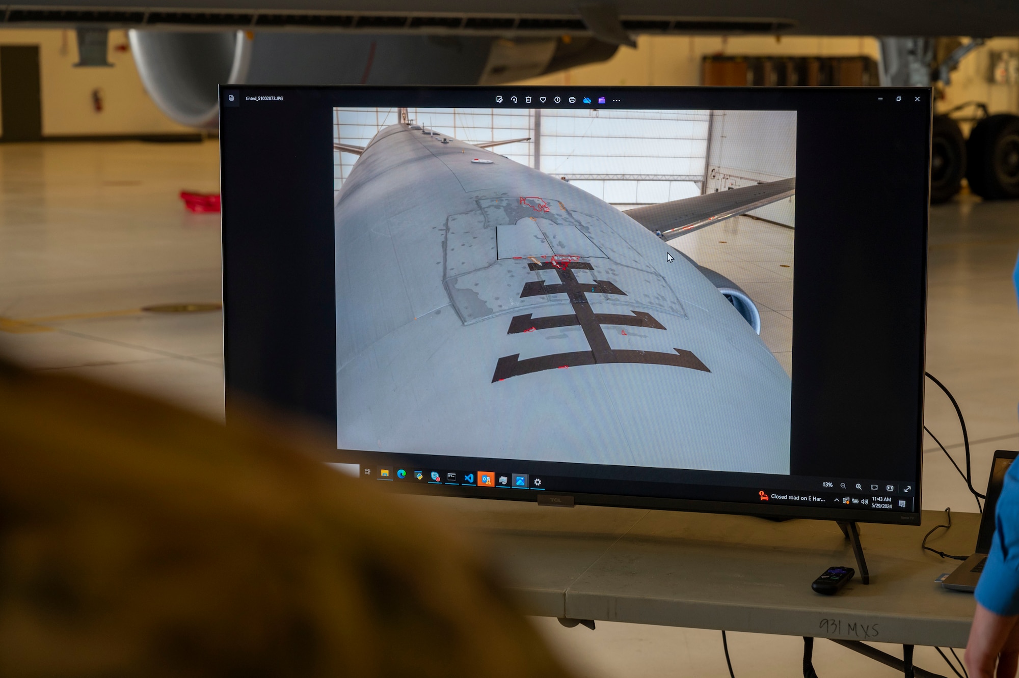 Airmen review a damage scan from a Skydio X10D drone May 29, 2024, at McConnell Air Force Base, Kansas. The X10D uses AI software to highlight and identify defects on aircraft, which maintenance Airmen can use to locate damages and save time. (U.S. Air Force photo by Airman 1st class Gavin Hameed)