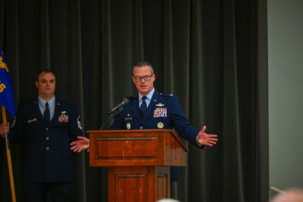 A commander speaks at a podium