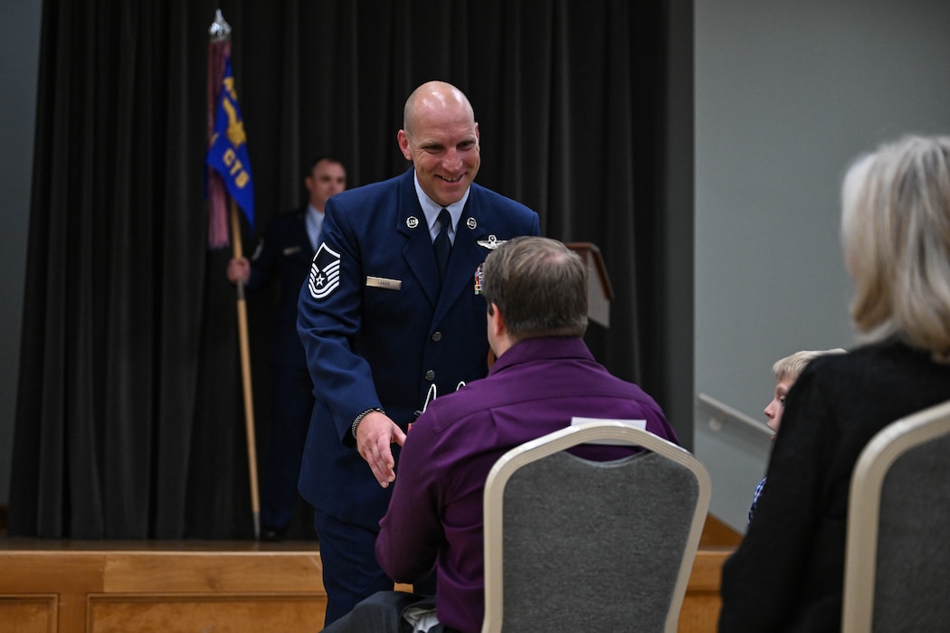 An airman presents a gift to a family member