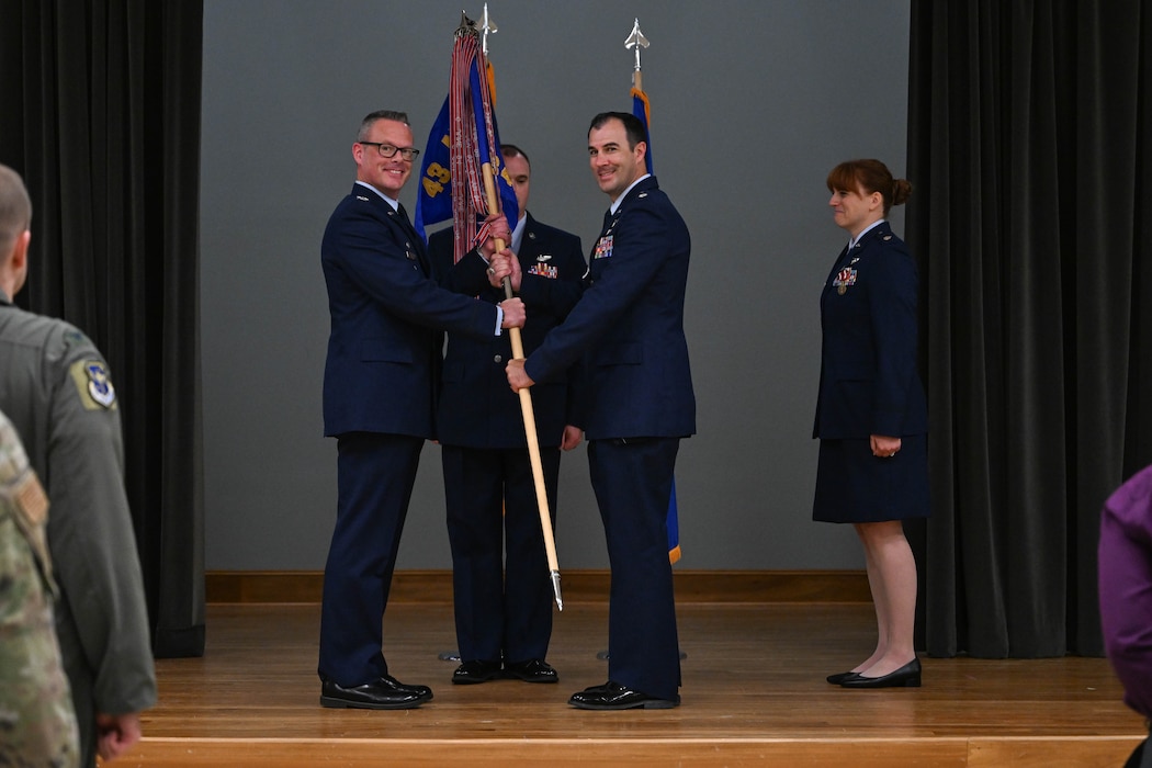 A group commander passes a flag to a squadron commander