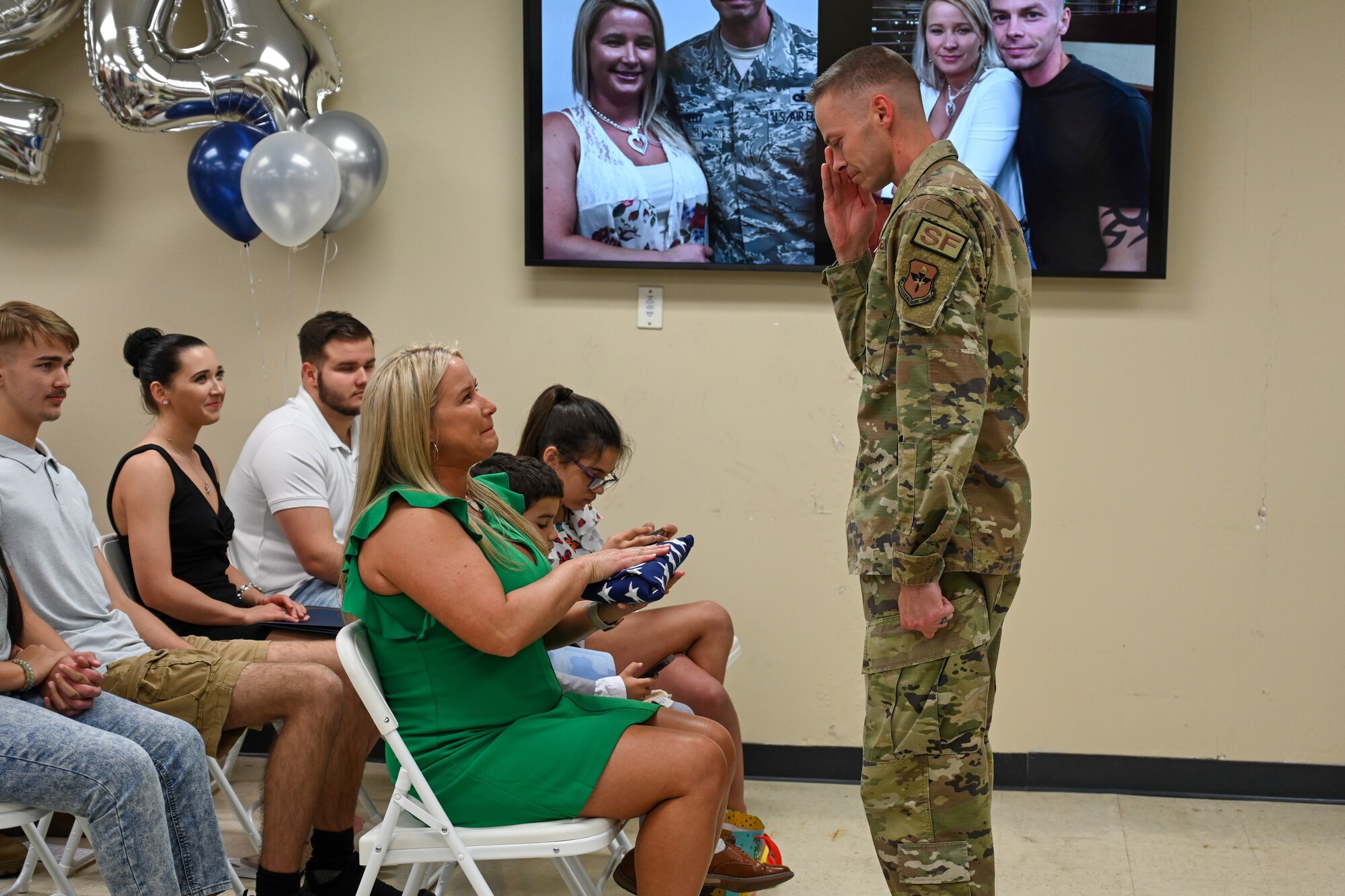 U.S. Air Force Master Sgt. Adam Neely, 97th Security Forces Squadron logistics readiness superintendent, presents a flag to his wife, Shelly Neely, 97th Logistics Readiness Squadron commander’s secretary, at Altus Air Force Base, Oklahoma, May 18, 2024. Neely retired after 20 years of service. (U.S. Air Force photo by Airman Lauren Torres)