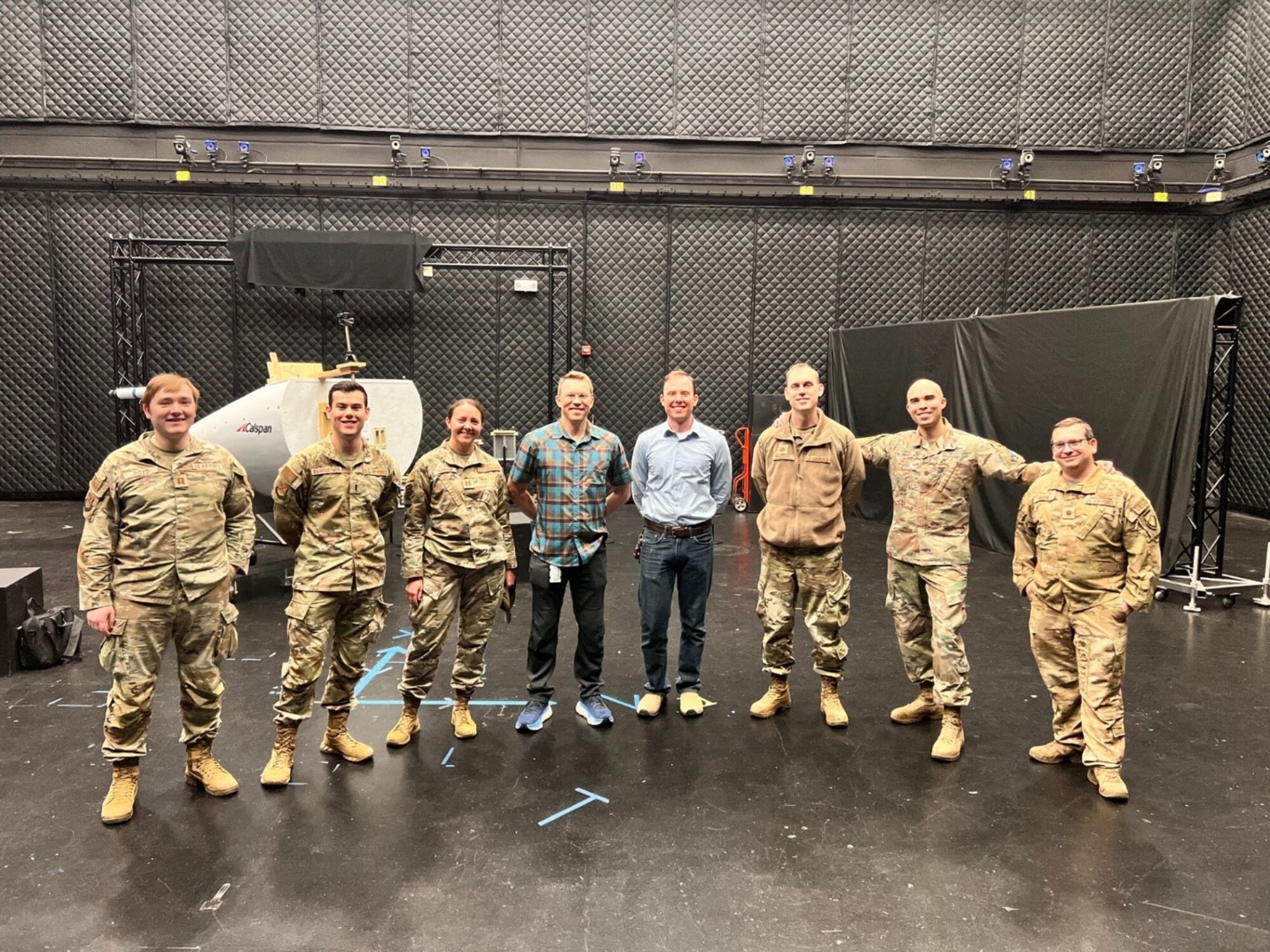 Scott Nykl (fourth from the left) with graduate students working in the lab. In the background is a nose cone out fitted with a Navy probe that is used for aerial refueling. (Contributed photo)