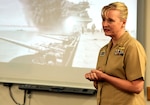 Commanding Officer Capt. Jennifer Buechel, Nurse Corps, Naval Medical Research Unit San Antonio, speaks to members of the command about the Battle of Midway during a commemoration ceremony held at the Battlefield Health and Trauma Research Institute. The Battle of Midway, one of the most important battles of the Pacific campaign in World War II, occurred between June 4-7, 1942. It is considered by many historians to be the most decisive engagement in modern naval warfare. (U.S. Navy photo by Burrell Parmer)
