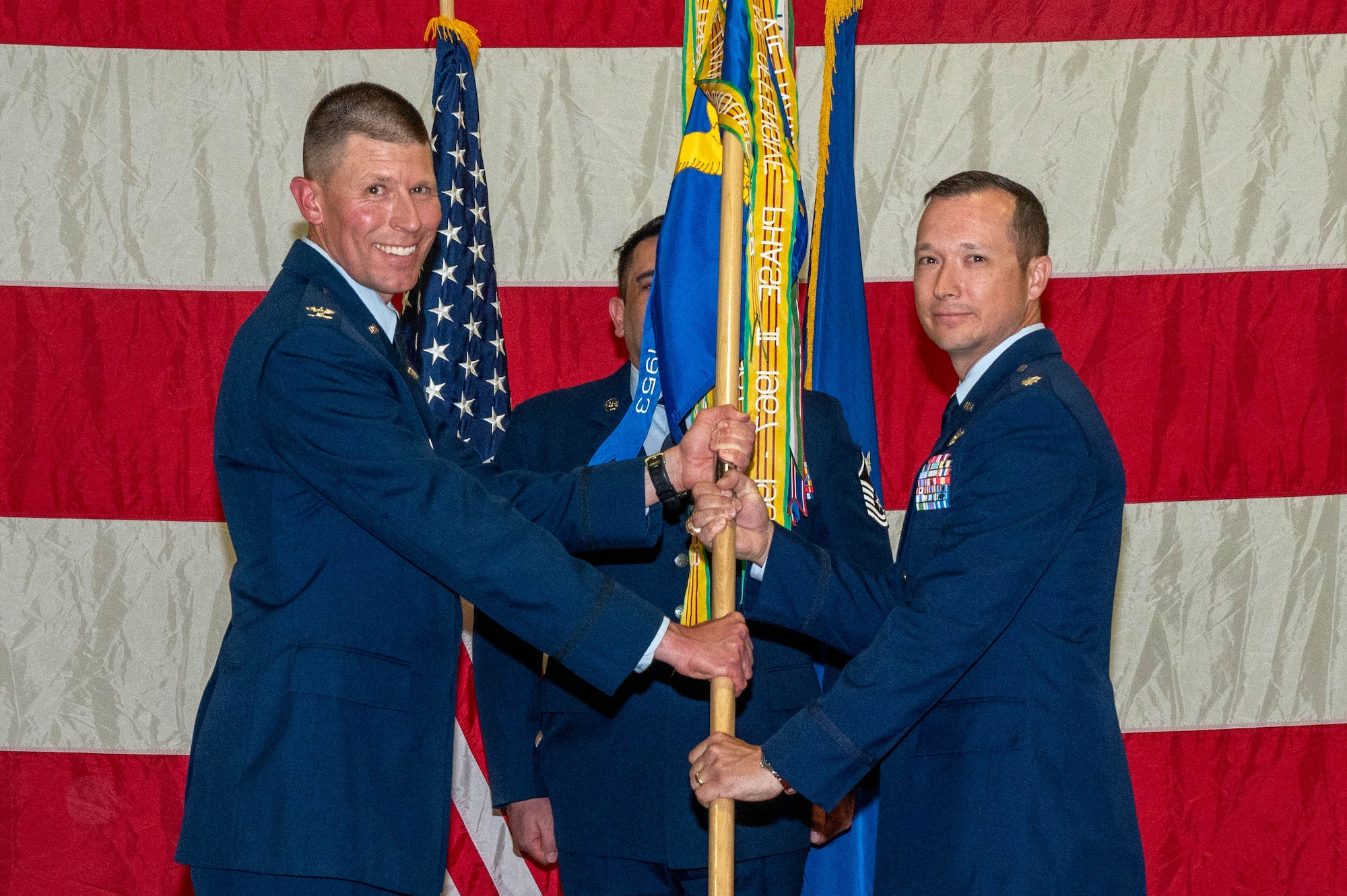 Col. Phillip Bryant passes the guidon to Lt. Col. Jason Pettengil.