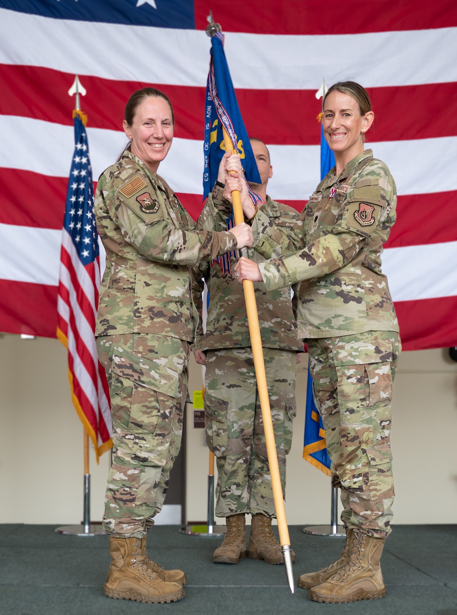 U.S. Air Force Lt. Col. Chandra R. Fleming, right, relinquishes command of the 51st Operations Support Squadron to Col. Kathryn K. Gaetke, left, 51st Operations Group commander, during a change of command ceremony at Osan Air Base, Republic of Korea, June 5, 2024. After relinquishing command, Fleming will serve as an instructor at Fort McNair, Washington, D.C. (U.S. Air Force photo by Senior Airman Brittany Russell)