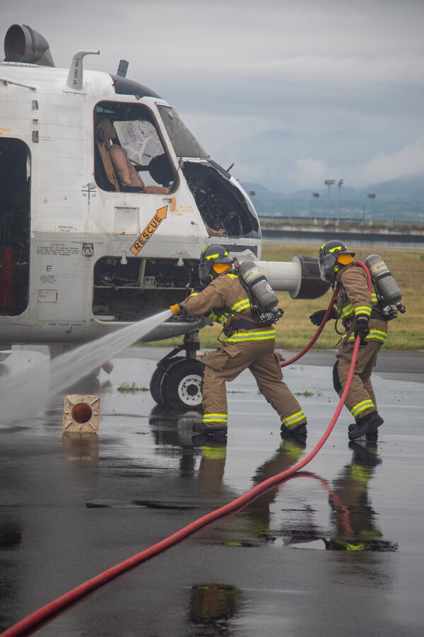 United States Marine Corps expeditionary firefighting and rescue specialists with Aircraft Rescue and Firefighting, Marine Corps Air Station Iwakuni, participate in a simulated fire training exercise at MCAS Iwakuni, May 31, 2024. MCAS Iwakuni Fire and Emergency Services and ARFF were recently recognized as the USMC Medium Fire Department of the Year for 2023 based on their high sustained performance. (U.S. Marine Corps photo by Lance Cpl. Rylan Adcock)