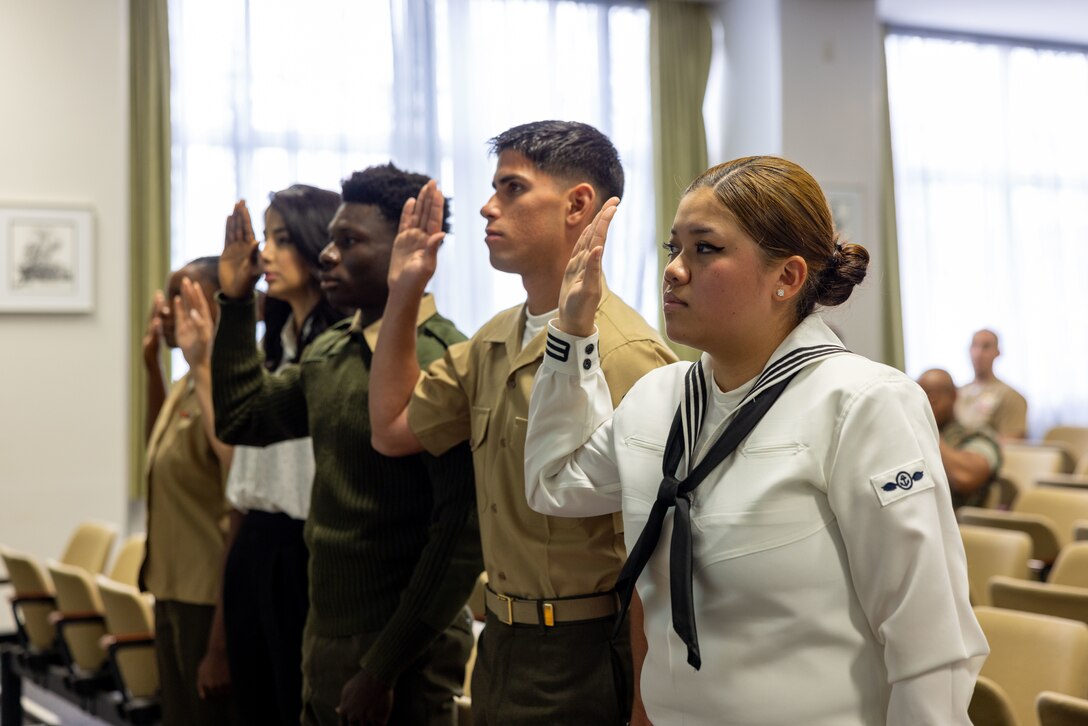 Members of the Marine Corps Air Station Iwakuni community swear in during a naturalization ceremony at MCAS Iwakuni, Japan, May. 31, 2024. The naturalization ceremony was conducted to welcome and celebrate the accomplishment of members of the MCAS Iwakuni community on becoming citizens of the United States. The ceremony included service members from Colombia, Cuba, Haiti, Nigeria, and Vietnam. (U.S. Marine Corps Photos by Cpl. Calah Thompson)