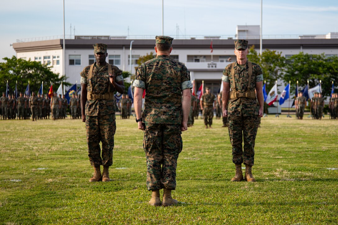 U.S. Marine Corps Sgt Maj. Jorge Cedeno-Tulloch, left, the outgoing sergeant major of Headquarters and Headquarters Squadron, Marine Corps Air Station Iwakuni, and a native of Panama, prepares to relinquish his duties by passing the noncommissioned officer sword to Lt. Col. Jacob Schwinghammer, the commanding officer of H&HS, MCAS Iwakuni, during a relief and appointment ceremony at MCAS Iwakuni, Japan, June 5, 2024. Relief and appointment ceremonies are a tradition that serve to represent the transition of responsibility from one sergeant major to another. (U.S. Marine Corps photo by Lance Cpl. Rylan Adcock)