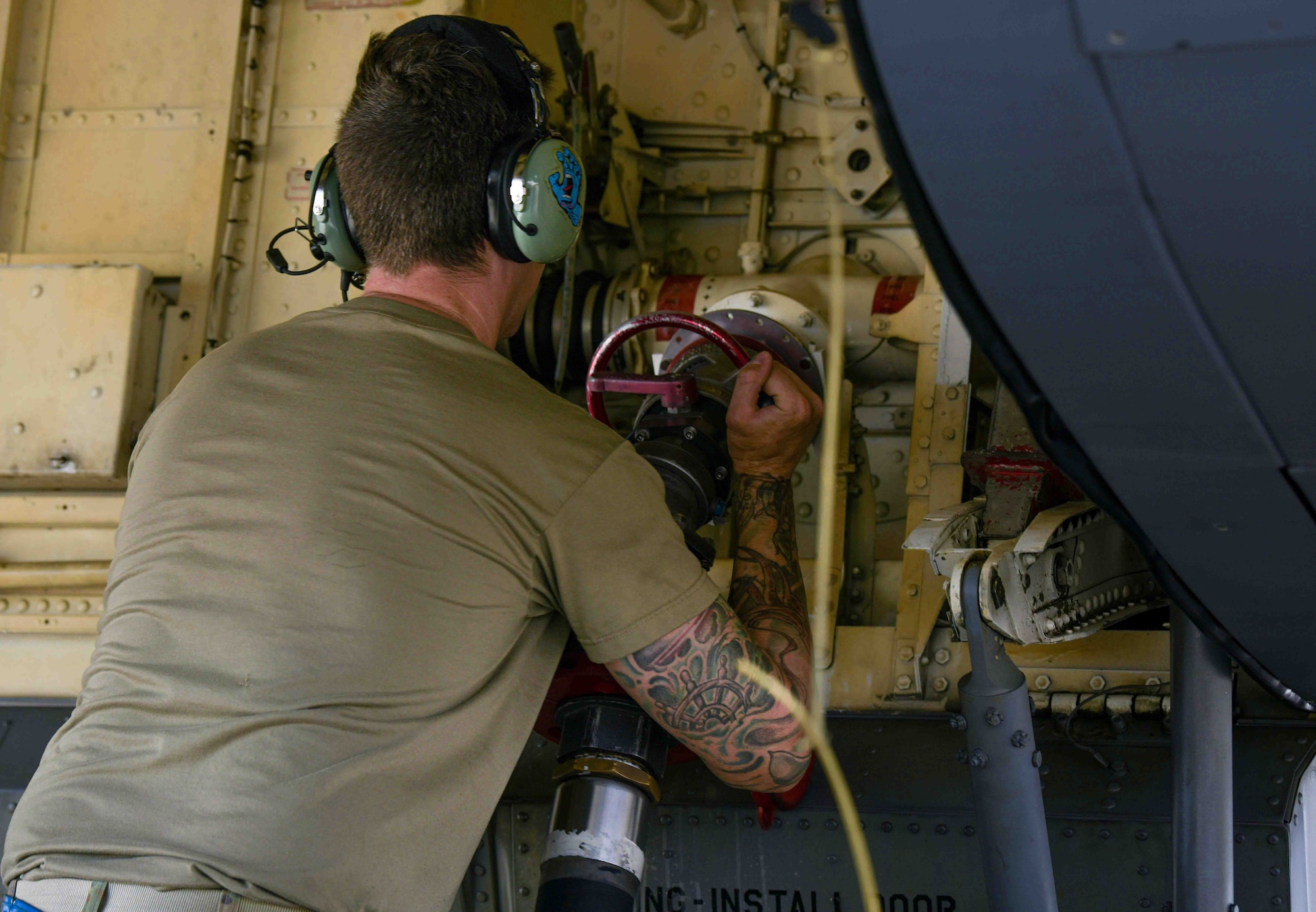 U.S. Air Force Senior Airman Corey Jackson, 909th Aircraft Maintenance Unit crew chief, removes the fuel hose from a KC-135 Stratotanker during a hot-pit refuel
