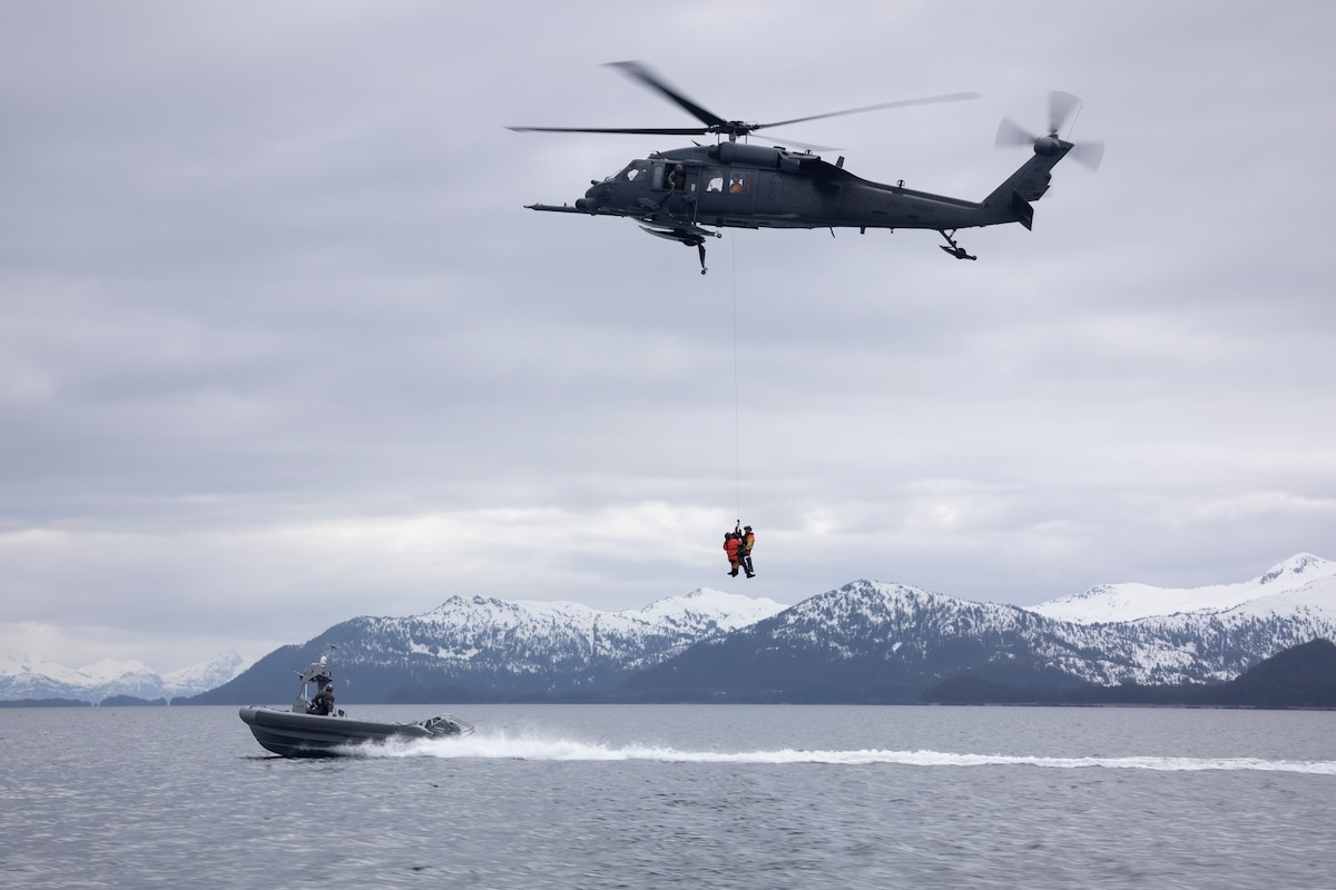 Alaska Air National Guard HH-60G Pave Hawk helicopter aviators assigned to the 210th Rescue Squadron hoist two 212th Rescue Squadron pararescuemen during underway hoist training in the Prince William Sound near Whittier, Alaska, May 16, 2024. The 212th, 210th and 211th RQSs make up the 176th Wing Rescue Triad and are among the busiest combat search and rescue units in the world.