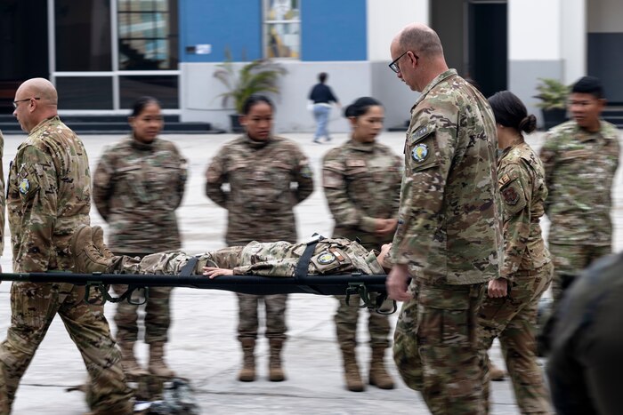 A Brazilian Air Force medical professional conducts Tactical Combat Casualty Care on a U.S. Air Force Airman assigned to the 167th Aeromedical Evacuation Squadron from McLaughlin Air National Guard Base, W.Va., as part of exercise Resolute Sentinel 2024 at Las Palmas Air Base in Lima, Peru, June 4, 2024.
