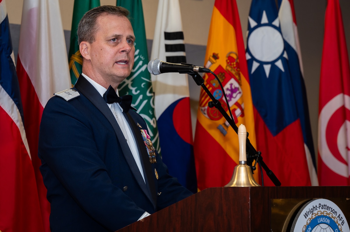 A man talks at a podium during the AFSAC/FLO International reception