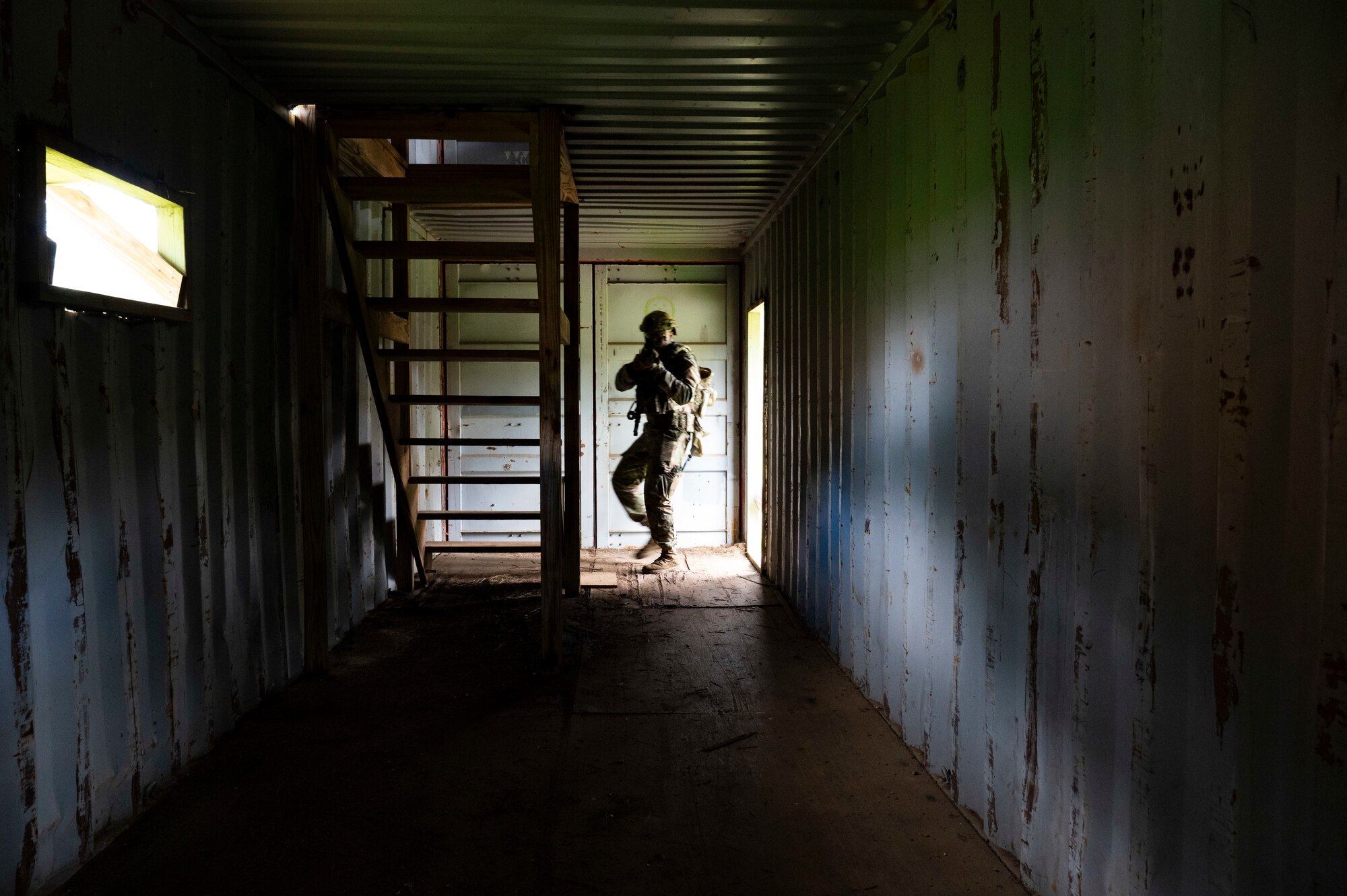 An Airman steps into a building.