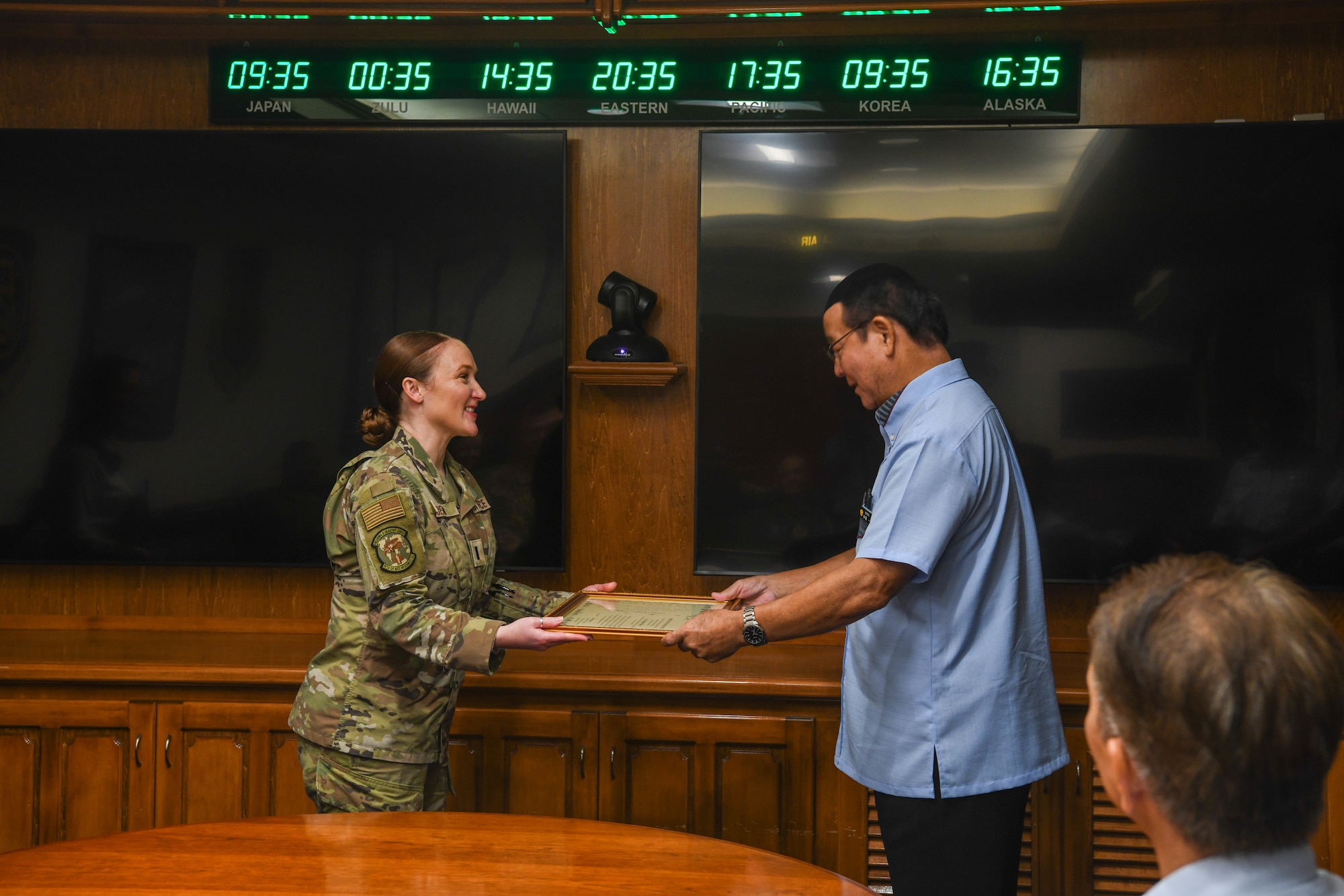 U.S. Air Force 1st Lt. Regina E. Bean receives a  certificate of appreciation.