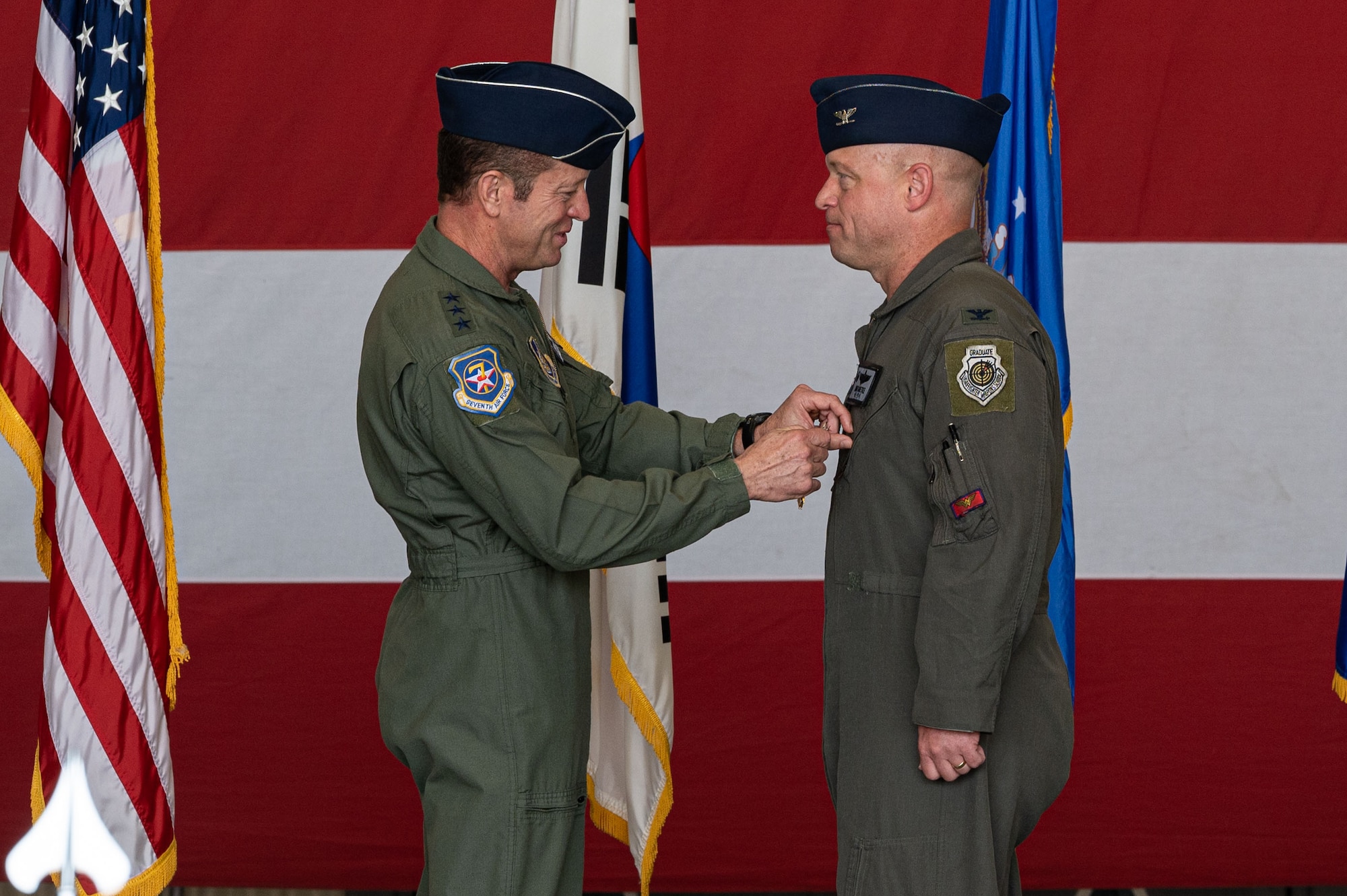 U.S. Air Force Col. Matthew Gaetke, 8th Fighter Wing outgoing commander, receives the Legion of Merit medal from Lt. Gen. David Iverson, 7th Air Force commander, during the 8th FW change of command ceremony.