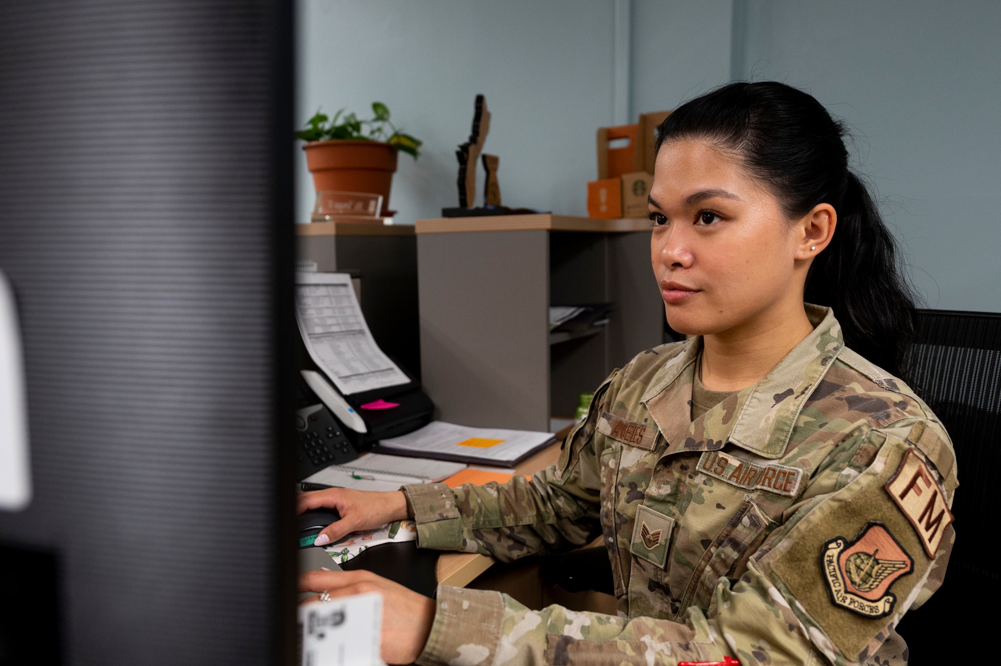U.S. Air Force Staff Sgt. Joy Angeles, 51st Comptroller Squadron financial analyst, processes funds at Osan Air Base, Republic of Korea, June 5, 2024. As a financial analyst, Angeles ensures Osan AB remains financially prepared to counter any threats as well as sustain mission operations effectively. (U.S. Air Force photo by Senior Airman Kaitlin Frazier)