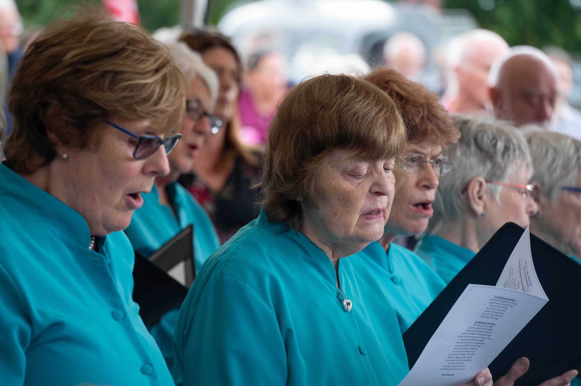 A choir sings the United Kingdom National Anthem.