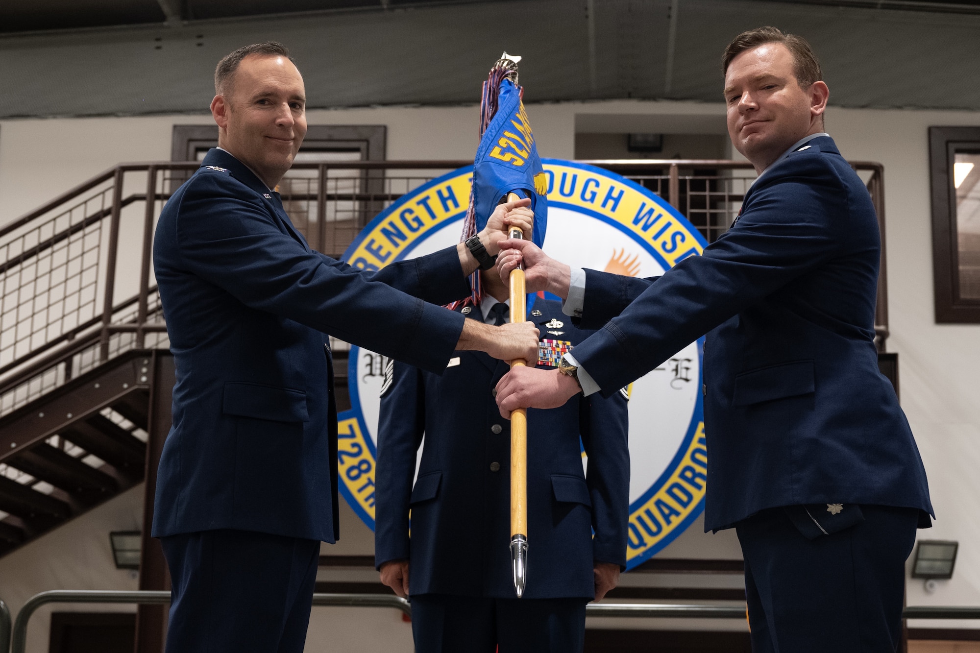 U.S. Air Force Lt. Col. Matthew Sobey, 728th Air Mobility Squadron commander, receives the unit guidon from Col. Lance Allred, 521st Air Mobility Group commander, during a change of command ceremony at Incirlik Air Base, Türkiye.
