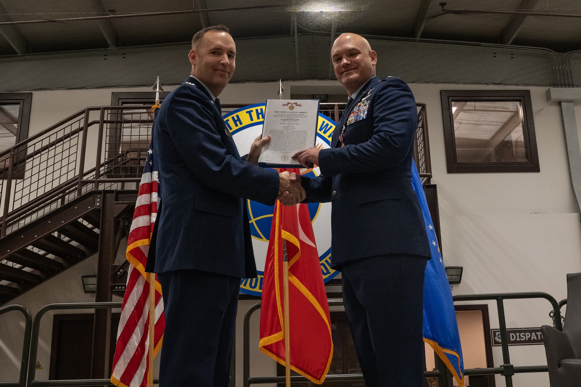 U.S. Air Force Col. Lance Allred, 521st Air Mobility Group commander, presents a decoration to Lt. Col. Richard Cramer, 728th Air Mobility Squadron commander, at a change of command ceremony at Incirlik Air Base, Türkiye.
