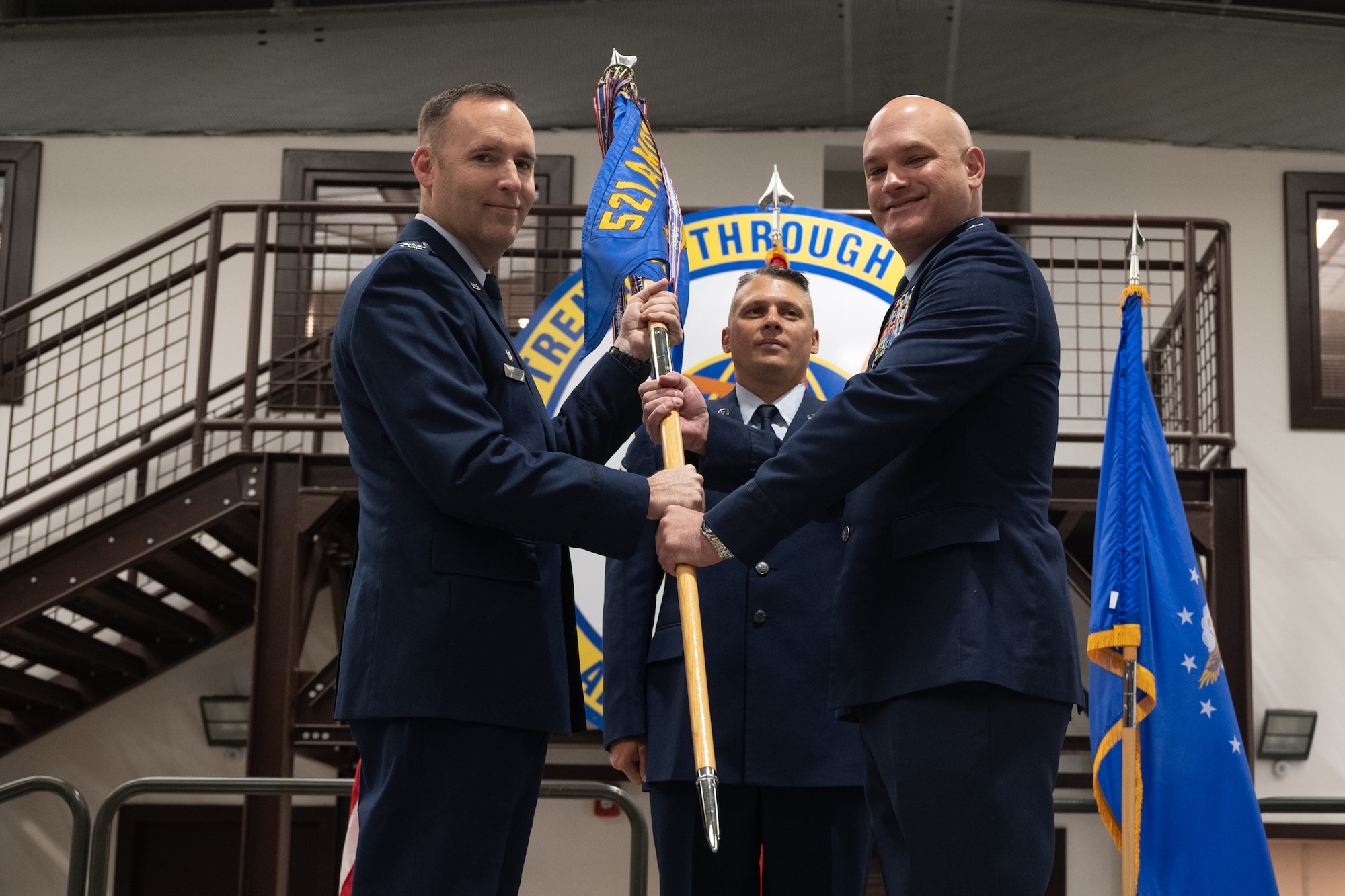 U.S. Air Force Lt. Col. Richard Cramer, 728th Air Mobility Squadron commander, relinquishes the unit guidon to Col. Lance Allred, 521st Air Mobility Group commander, during a change of command ceremony at Incirlik Air Base, Türkiye