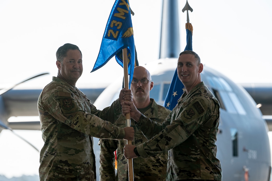 U.S. Air Force Col. Bobby Buckner, left, 23rd Maintenance Group commander, receives the guidon from Maj. Patrick Britton, 71st Rescue Generation Squadron outgoing commander, during a change of command ceremony at Moody Air Force Base, Georgia, June 3, 2024. Britton led over 260 personnel in the sortie generation of 10 HC-130J Combat King II aircraft assigned to Moody AFB. (U.S. Air Force photo by Airman 1st Class Leonid Soubbotine)