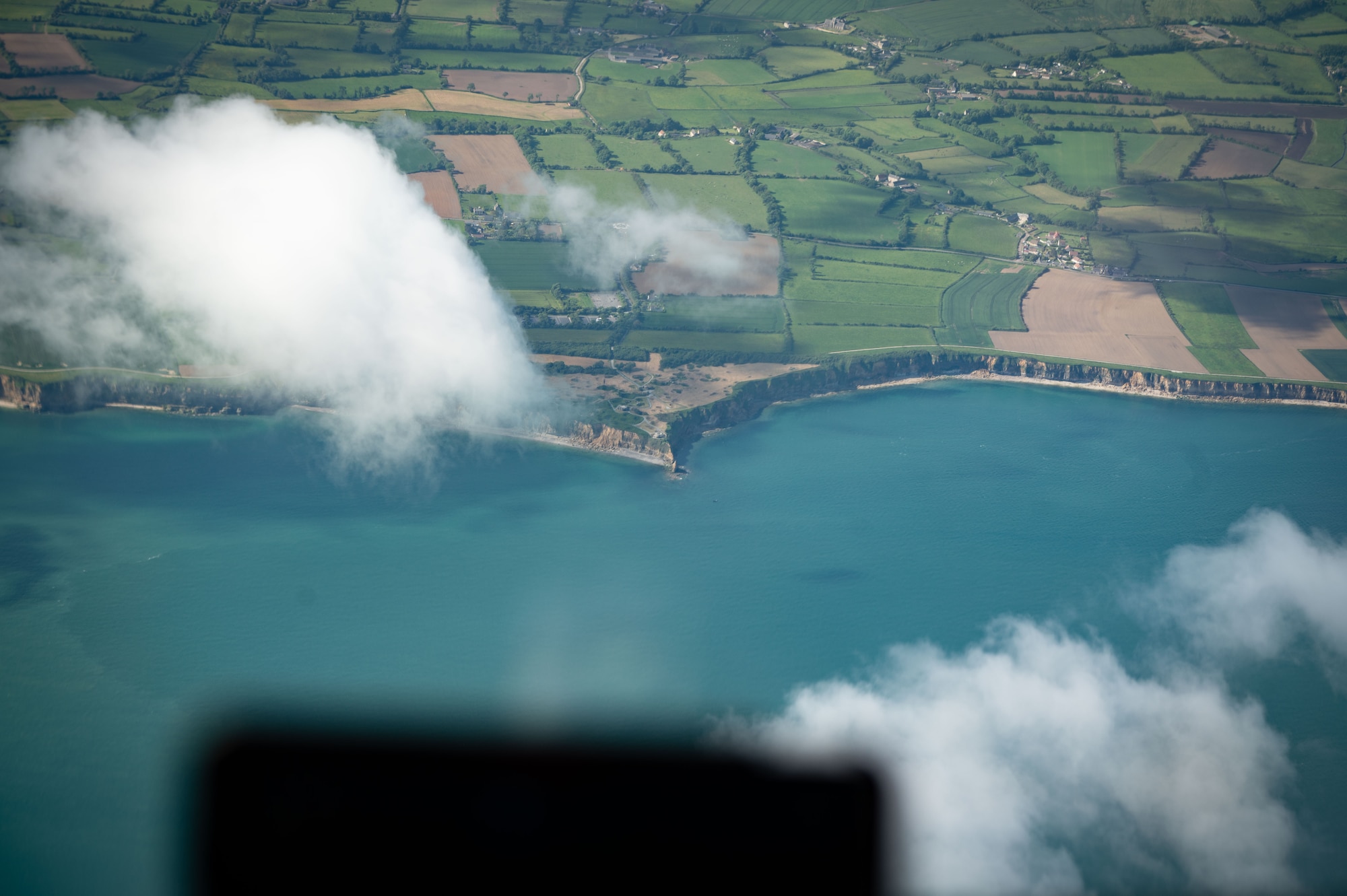 A U.S. Air Force KC-46 Pegasus from the 305th Air Mobility Wing flies over Point Du Hoc and the right flank of Omaha beach, Normandy, France, May 26, 2024. The 100th Air Refueling Wing, 48th Fighter Wing and 305th AMW conducted a flyover at Normandy American Cemetery for a Memorial Day ceremony to honor and remember American service members who made the ultimate sacrifice. (U.S. Air Force photo by 2nd Lt. Alexis Kula)