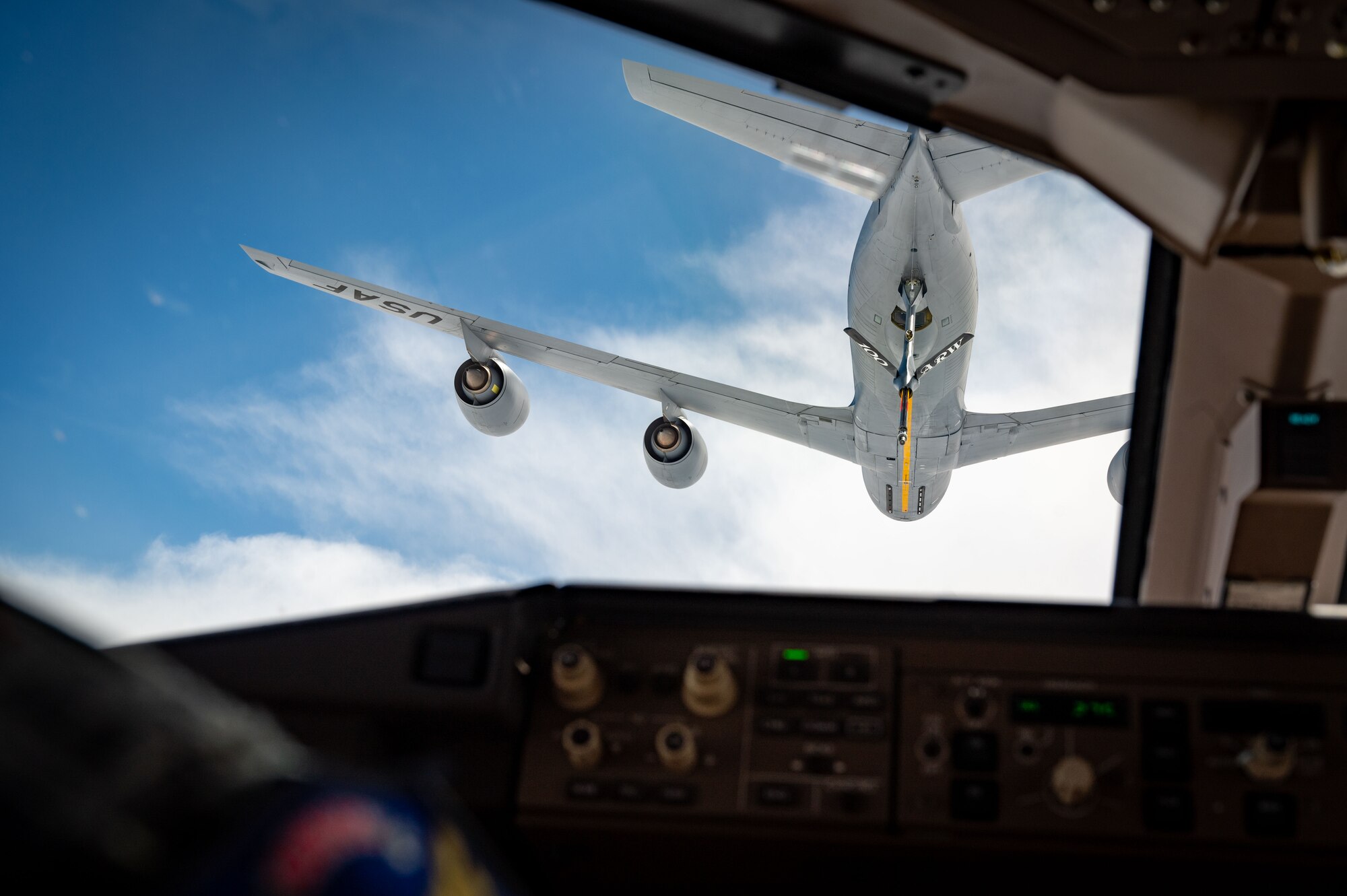 A U.S. Air Force KC-46 Pegasus from the 305th Air Mobility Wing simulates receiving fuel from a KC-135 Stratotanker from the 100th Air Refueling Wing, Royal Air Force Mildenhall, England, over the North Sea, May 26, 2024. The 100th ARW, 48th Fighter Wing and 305th AMW conducted a flyover at Normandy American Cemetery, France, for a Memorial Day ceremony to honor and remember American service members who made the ultimate sacrifice. (U.S. Air Force photo by 2nd Lt. Alexis Kula)