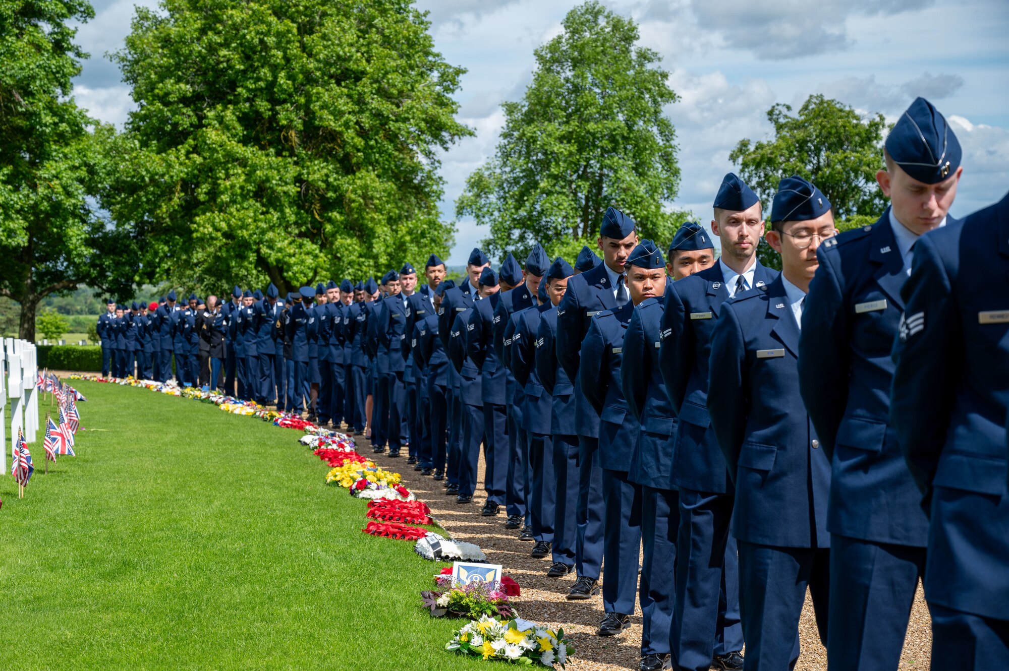 U.S. Air Force Airmen from the 305th Air Mobility Wing and Royal Air Force Mildenhall pay respects to fallen service members at the Cambridge American Cemetery, England, May 27, 2024. The 305th AMW hosted its heritage trip for the third consecutive year to learn about its forebearer, the 305th Bombardment Group, who was crucial to the nation’s triumph against Nazi Germany in World War II. (U.S. Air Force photo by 2nd Lt. Alexis Kula)